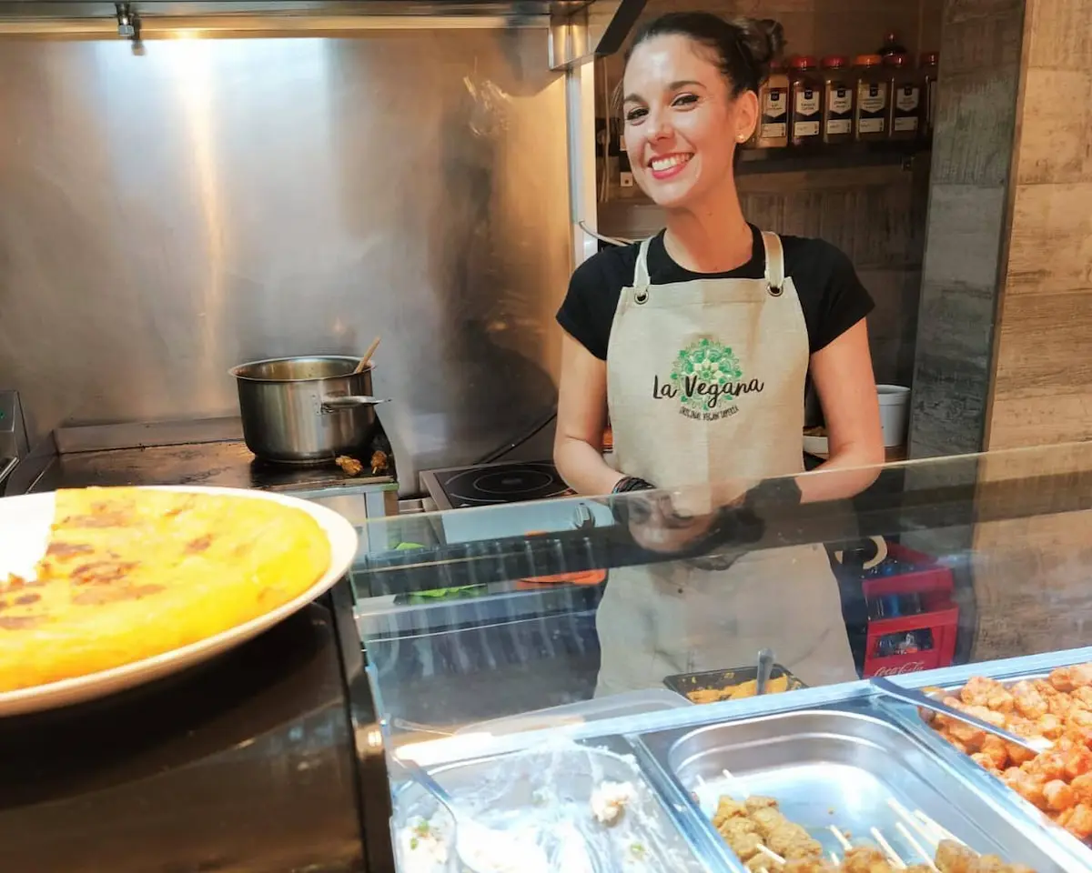 Worker behind the bar at La Vegana restaurant in Malaga